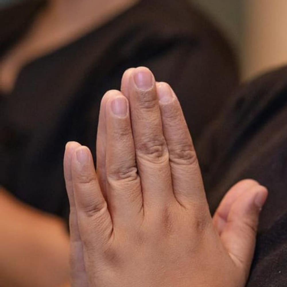 A Knot Whisperer's hands, held in greeting