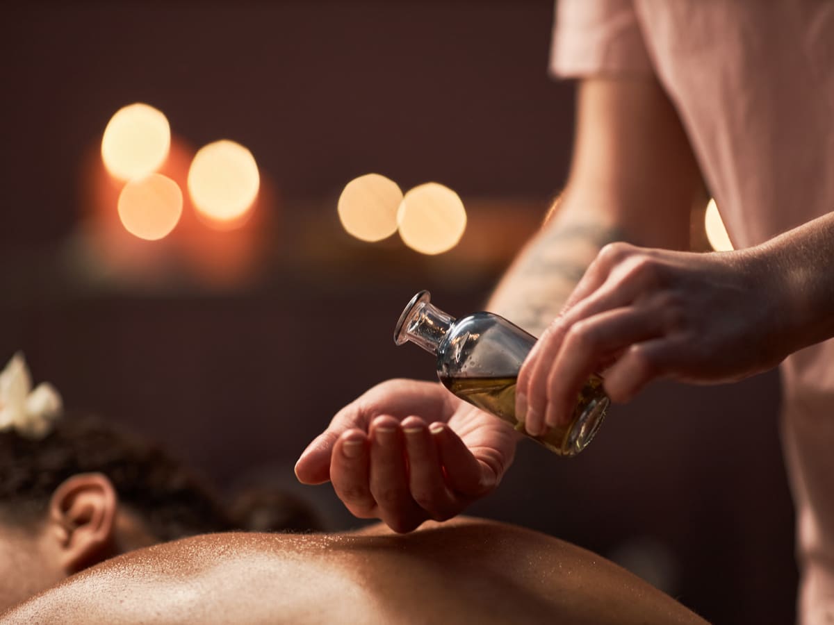 Warm oil poured for a flowing massage